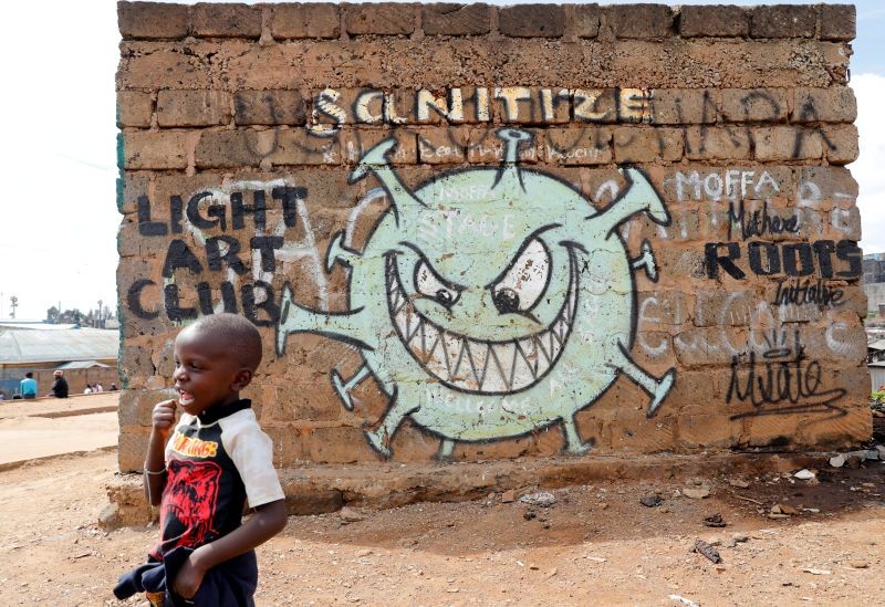 A boy stands in front of a graffiti promoting the fight against the coronavirus disease (COVID-19) in the Mathare slums of Nairobi, Kenya on May 22, 2020. (REUTERS File Photo)
