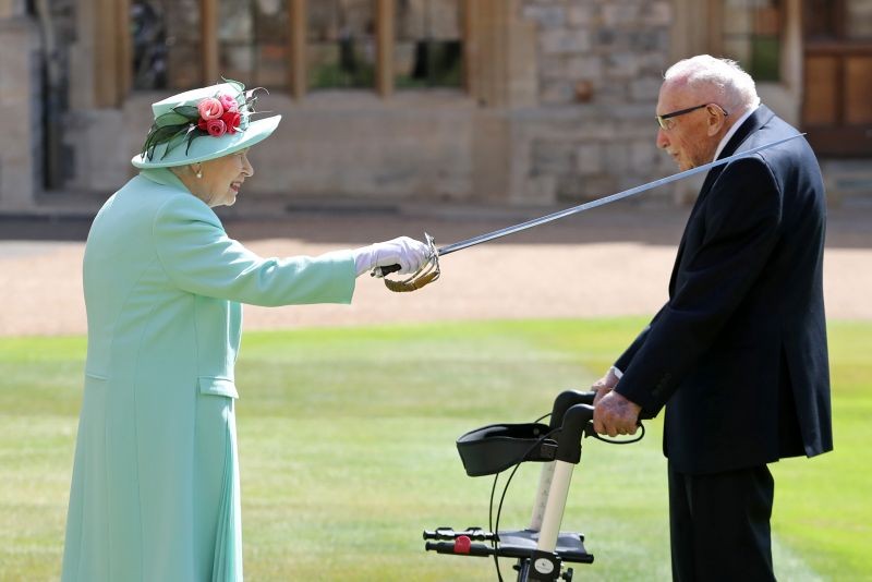 Britain's Queen Elizabeth awards Captain Tom Moore with the insignia of Knight Bachelor at Windsor Castle, in Windsor, Britain on July 17. (REUTERS Photo)