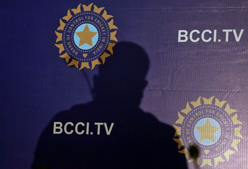 The shadow of a man falls on a backdrop with the logo of the India's cricket board BCCI before the start of a news conference to announce its cricket team's coach, in Mumbai, India, August 16, 2019. REUTERS/Francis Mascarenhas