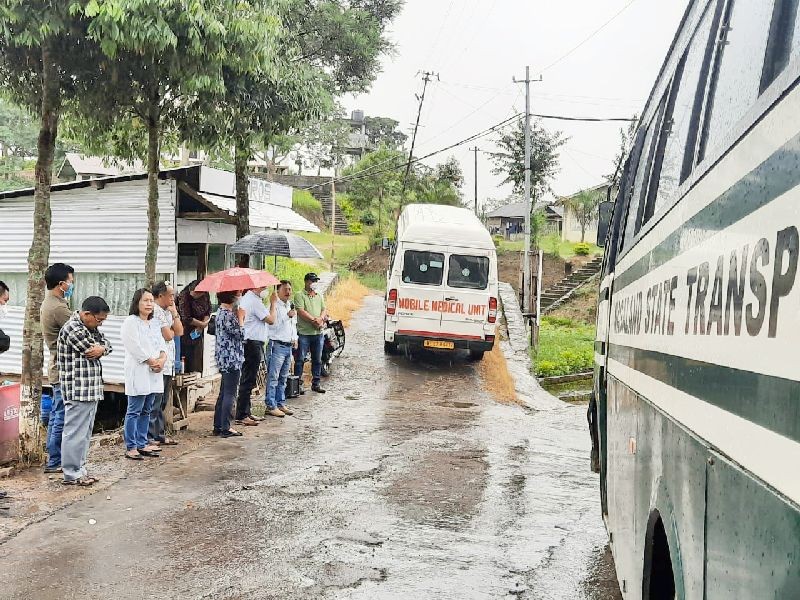 Mokokchung district administration officials and others sending off the occupants of a quarantine centre for home quarantine.