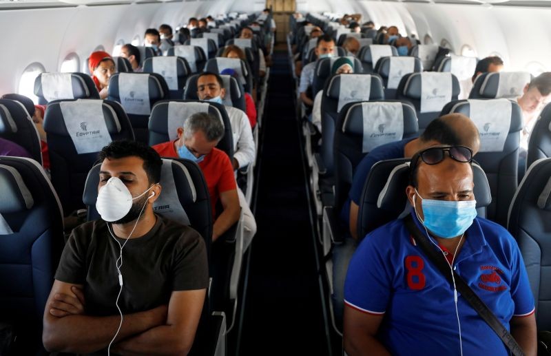 Passengers wearing protective face masks sit on a plane at Sharm el-Sheikh International Airport, following the outbreak of the coronavirus disease (COVID-19), in Sharm el-Sheikh, Egypt on June 20, 2020. (REUTERS File Photo)