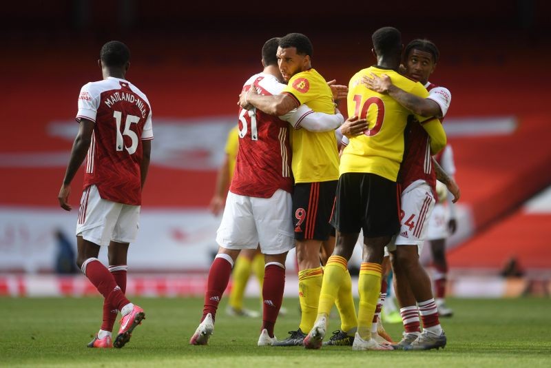Watford's Troy Deeney and Danny Welbeck are embraced by Arsenal's Sead Kolasinac and Reiss Nelson after Watford are relegated from the Premier League at the end of the match, as play resumes behind closed doors following the outbreak of the coronavirus disease (COVID-19) Pool via REUTERS/Neil Hall
