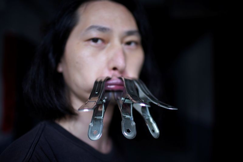 Brother Nut, Chinese performance artist with three metallic clips sealing his mouth, poses for a picture in Shanghai, following the coronavirus disease (COVID-19) outbreak, China on July 13, 2020. (REUTERS File Photo)