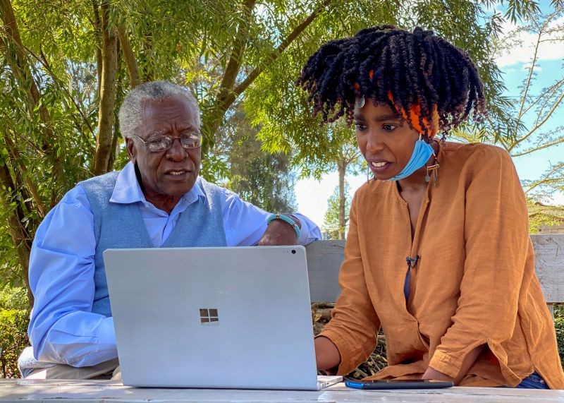 Chao Tayiana, a digital historian, and her grandfather Daniel Sindiyo, whose mother was in the British detention camps of the pre-independence Mau Mau rebellion, look at the reconstructed 3D models of the detention camps, during a Reuters interview in Ngong, outside Nairobi, Kenya on June 29, 2020. (REUTERS File Photo)