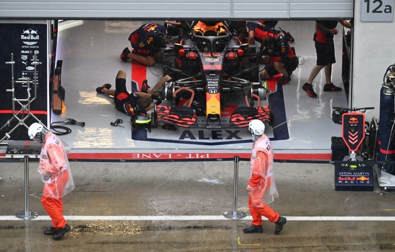 Red Bull engineers with Alexander Albon's car in the garage as rain delays qualifying, following the resumption of F1 after the outbreak of the coronavirus disease (COVID-19) on July 11, 2020. Joe Klamar/Pool via REUTERS