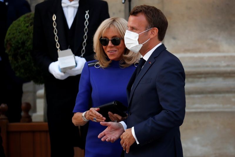 French President Emmanuel Macron wears a protective face mask as he leaves with his wife Brigitte after giving a speech to the French Military Forces at the Hotel de Brienne in Paris, France on July 13, 2020. (REUTERS Photo)