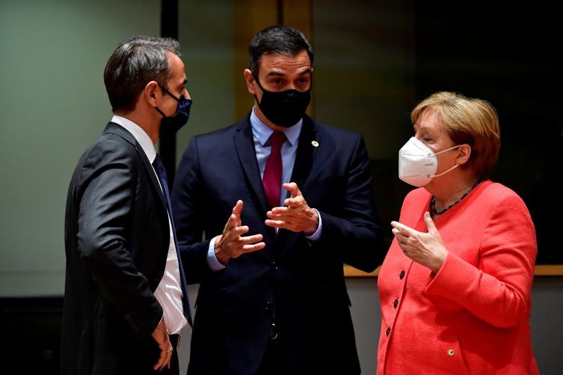 Greek Prime Minister Kyriakos Mitsotakis, Spain's Prime Minister Pedro Sanchez and German Chancellor Angela Merkel speak during the first face-to-face EU summit since the coronavirus disease (COVID-19) outbreak, in Brussels, Belgium on July 20, 2020. (REUTERS Photo)