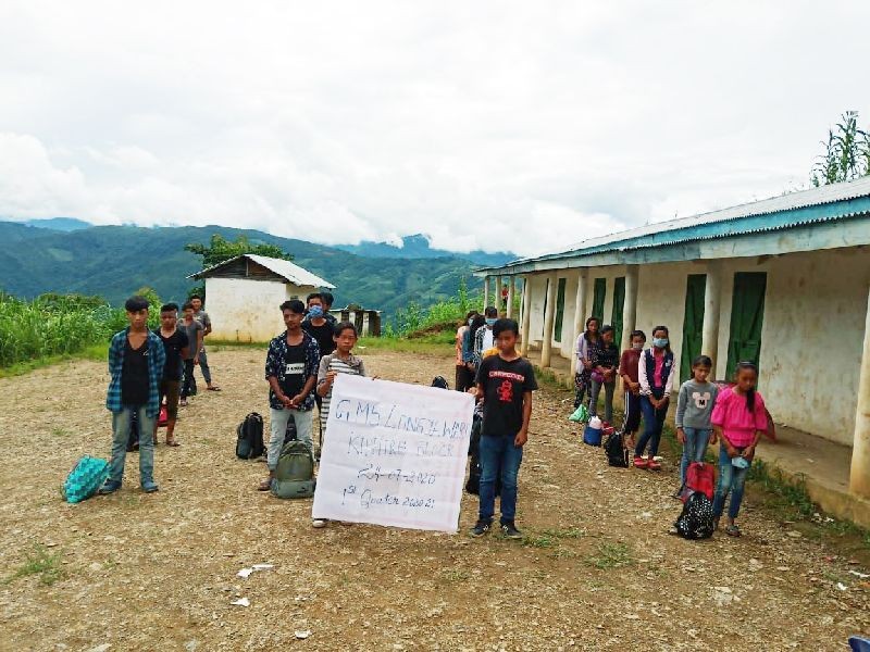 Students of Government Middle School, Longya Ward, Kiphire receives mid day meal at the School premise on July 24.