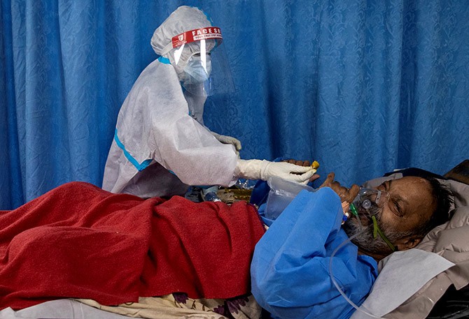 A medical worker wearing personal protective equipment tends to a patient suffering from the coronavirus in the Intensive Care Unit at Lok Nayak Jai Prakash hospital in New Delhi. Photograph: Danish Siddiqui/Reuters