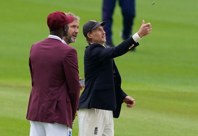 England's Joe Root and West Indies' Jason Holder during the coin toss, as play resumes behind closed doors following the outbreak of the coronavirus disease (COVID-19) Jon Super/Pool via REUTERS