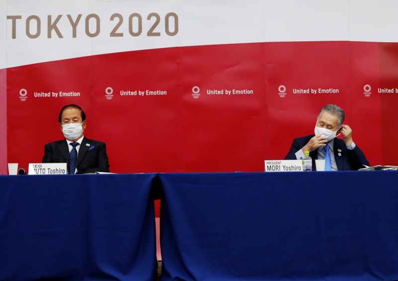 Yoshiro Mori, President of the Tokyo 2020 Olympic Games Organising Committee, and CEO Toshiro Muto wearing protective face masks attend a news conference after giving a presentation to the International Olympic Committee (IOC) about progress towards the rearranged the summer games next year, in Tokyo, Japan. (Reuters File Photo)