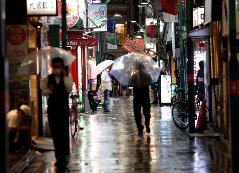 Passersby wearing protective face masks walk on the street amid the coronavirus disease (COVID-19) outbreak, at Ikebukuro's amusement district in Tokyo, Japan on July 9, 2020.  (REUTERS File Photo)