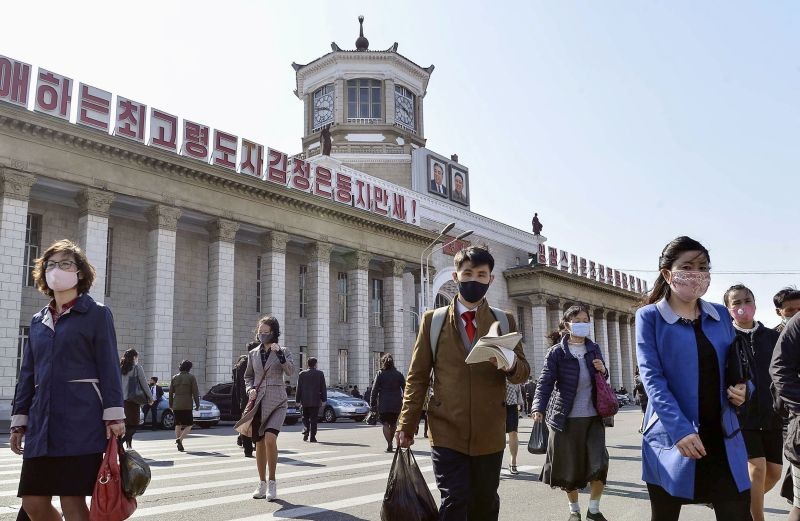 People wearing protective face masks walk amid concerns over the new coronavirus disease (COVID-19) in front of Pyongyang Station in Pyongyang, North Korea on April 27, 2020, in this photo released by Kyodo. (REUTERS File Photo)