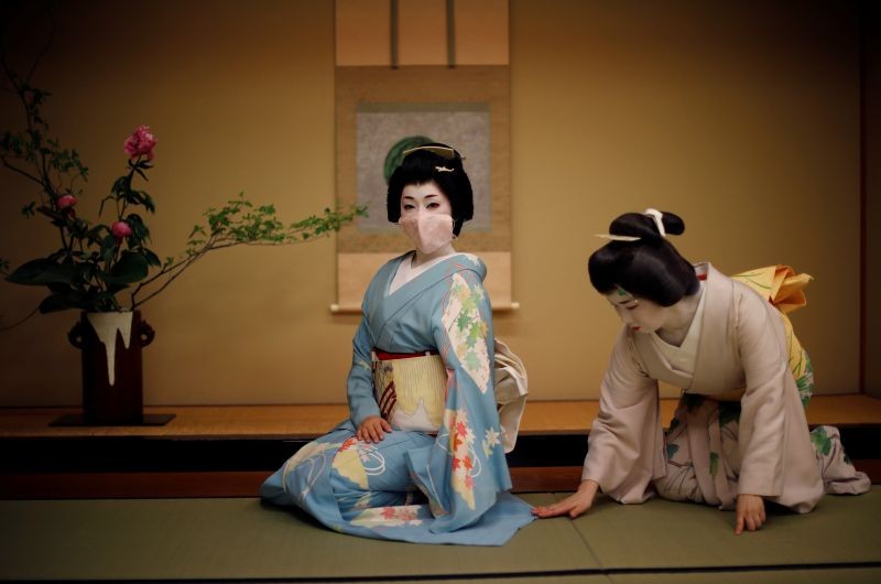 Mayu adjusts Koiku's kimono, both of who are geisha, as Koiku wears a protective face mask to pose for a photograph, before working at a party being hosted by customers, where they will entertain with other geisha, at Asada, a luxury Japanese restaurant, during the coronavirus (COVID-19) outbreak, in Tokyo, Japan on June 23, 2020. "My father really didn't understand geisha, he thought it was like the sex trade. He opposed me so violently I thought it would tear the family apart", said Mayu. "After six years I just gave up and left", she added. "When he saw our first performance, and how hard we work, he came backstage and went to his knees and bowed really low ... Now he's a huge fan." (REUTERS File Photo)