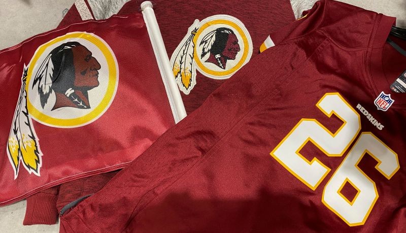 FILE PHOTO: Washington Redskins football shirts and a team flag on sale at a sporting goods store in Bailey's Crossroads, Virginia, U.S., June 24, 2020. REUTERS/Kevin Lamarque/File Photo