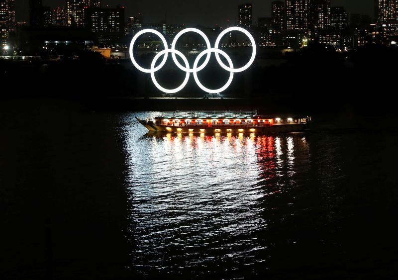FILE PHOTO: A Japanese-style tour boat called "Yakatabune" sails in front of giant Olympic rings at the waterfront area as the spread of the coronavirus disease (COVID-19) continues, at Odaiba Marine Park in Tokyo, Japan, June 2, 2020. REUTERS/Issei Kato/File photo