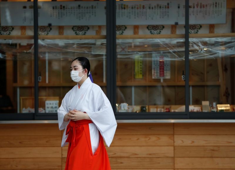 A Shinto maiden wearing a protective face mask walks at a shrine amid the coronavirus disease (COVID-19) outbreak, in Tokyo, Japan on July 15. (REUTERS Photo)