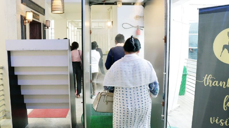 Worshippers at House Church in Chumüokedima going through an automatic body sanitizing chamber.