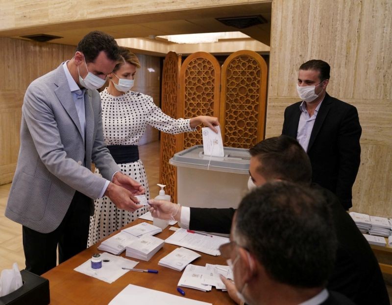 Syria's President Bashar al-Assad and his wife Asma cast their vote inside a polling station during the parliamentary elections in Damascus, Syria in this handout released by SANA on July 19, 2020. (REUTERS Photo)