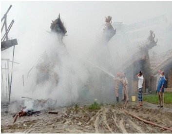 Fire personnel dousing the flames at a fire which broke out in a Quarantine Centre kitchen at Loyem Ground, Tuensang on July 6.