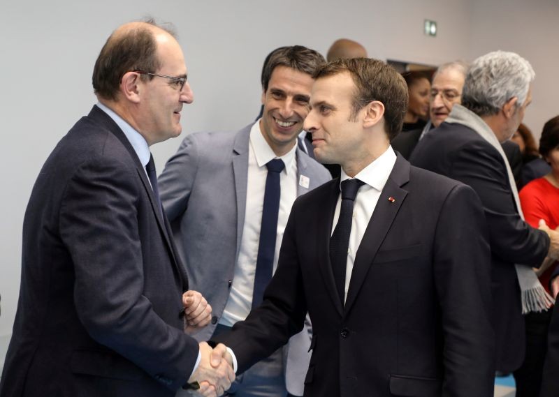 French President Emmanuel Macron shakes hands with Interministerial Delegate for the Olympic and Paralympic Games 2024 Jean Castex (L) flanked by President of the Paris Organising Committee of the 2024 Olympic and Paralympic Games Tony Estanguet during the inauguration of a new handball complex in Creteil, on the outskirts of Paris, France on January 9, 2019. (REUTERS File Photo)