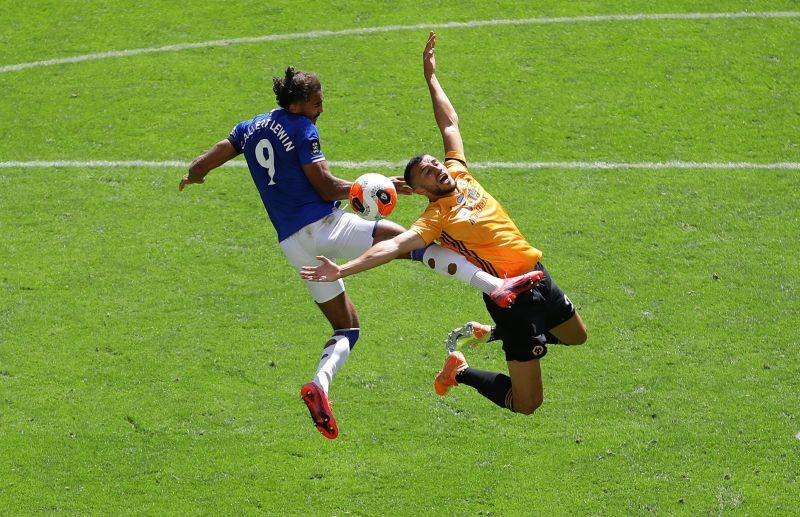 Everton's Dominic Calvert-Lewin in action with Wolverhampton Wanderers' Romain Saiss, as play resumes behind closed doors following the outbreak of the coronavirus disease (COVID-19) Richard Heathcote/Pool via REUTERS