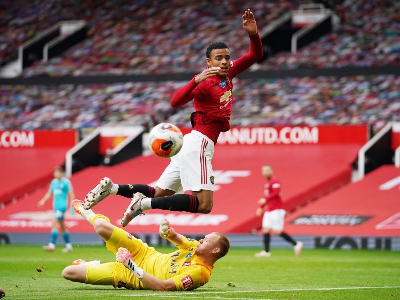 Manchester United's Mason Greenwood in action with Bournemouth's Aaron Ramsdale, as play resumes behind closed doors following the outbreak of the coronavirus disease (COVID-19) Dave Thompson/Pool via REUTERS