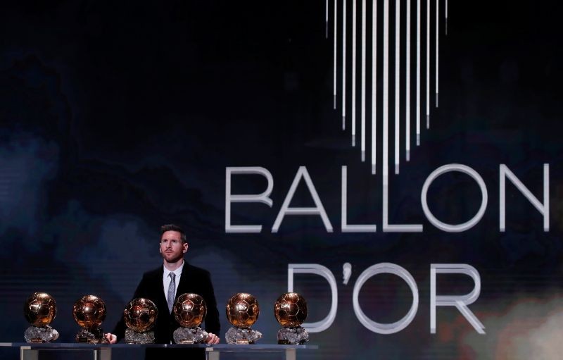 FILE PHOTO: Soccer Football - The Ballon d’Or awards - Theatre du Chatelet, Paris, France - December 2, 2019 Barcelona's Lionel Messi with his six Ballon d'Or trophies REUTERS/Christian Hartmann