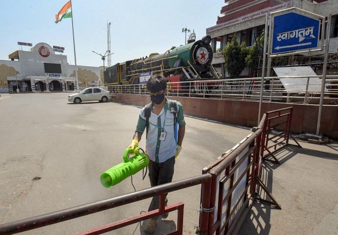 A health worker carries out sanitisation work outside the Patna Junction. Photograph: PTI Photo
