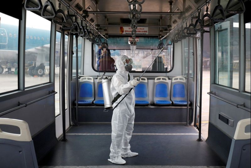 A health worker sprays disinfectant inside a bus to protect from the recent coronavirus outbreak, at Noi Bai airport in Hanoi, Vietnam on February 21, 2020. (REUTERS File Photo)