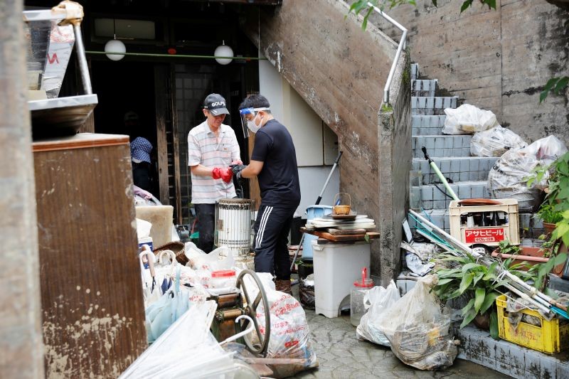 People work as they clear debris after floods caused by torrential rain in Hitoyoshi, Kumamoto Prefecture, southwestern Japan on July 8, 2020.( REUTERS Photo)