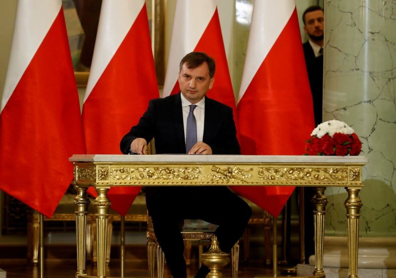 Zbigniew Ziobro signs documents after being designated as Minister of Justice, at the Presidential Palace in Warsaw, Poland on November 15, 2019. (REUTERS File Photo)