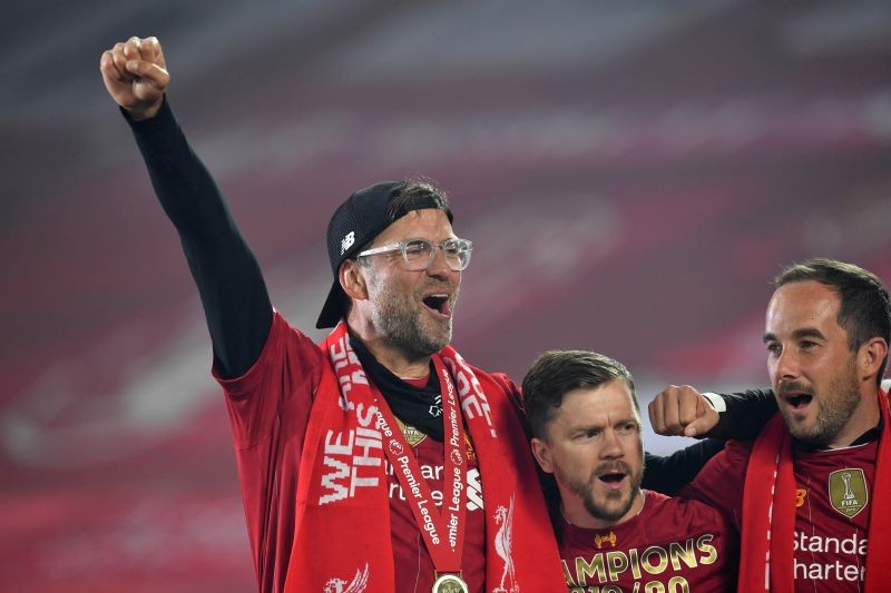 FILE PHOTO: Soccer Football - Premier League - Liverpool v Chelsea - Anfield, Liverpool, Britain - July 22, 2020 Liverpool manager Juergen Klopp celebrates with his players after winning the Premier League Pool via REUTERS/Paul Ellis