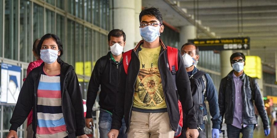 Passengers wear masks in the wake of coronavirus pandemic at the Kolkata airport. (Photo | PTI)