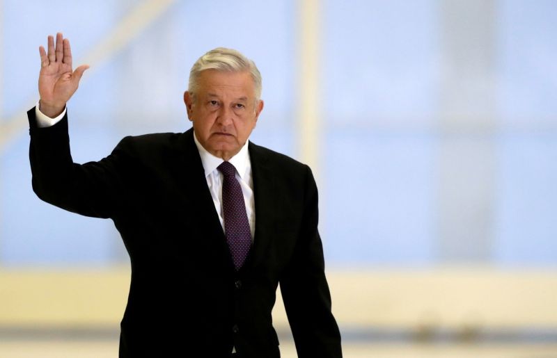 Mexico's President Andres Manuel Lopez Obrador waves as he arrives to hold a news conference at the presidential hangar, with the presidential plane in the background, at Benito Juarez International Airport in Mexico City, Mexico on July 27, 2020. (REUTERS File Photo)