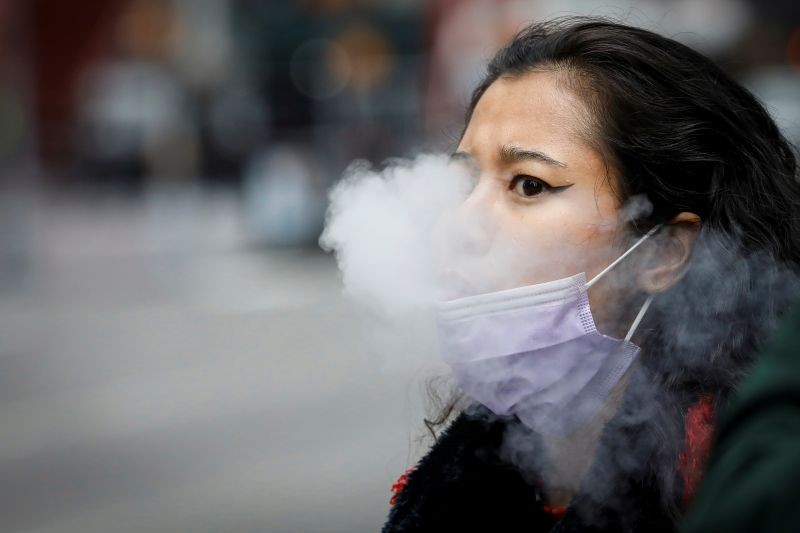 A woman exhales after vaping in Times Square, during the coronavirus disease (COVID-19) outbreak, in New York City, US on March 31, 2020. (REUTER File Photo)
