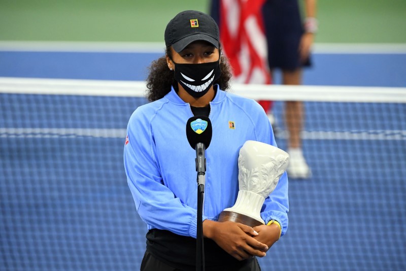 FILE PHOTO: Aug 29, 2020; Flushing Meadows, New York, USA; Naomi Osaka (JPN) with her 2nd place trophy on the court during the awards ceremony for singles champion Victoria Azarenka (BLR) in the Western & Southern Open at the USTA Billie Jean King National Tennis Center. Osaka withdrew from the Western & Southern Open final due to a left hamstring injury. Mandatory Credit: Robert Deutsch-USA TODAY Sports/File photo