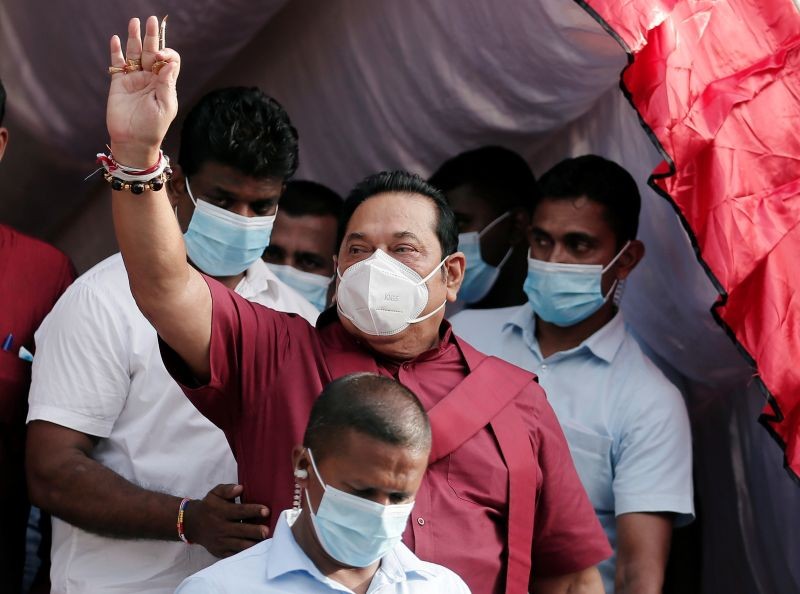 Leader of Sri Lanka People's Front party Mahinda Rajapaksa, wearing a protective mask, waves at his supporters during a campaign rally  on  August 1, 2020. (REUTERS File Photo)