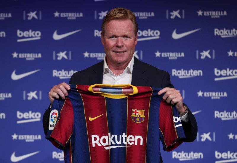 Barcelona coach Ronald Koeman poses with a Barcelona shirt during the unveiling REUTERS/Albert Gea