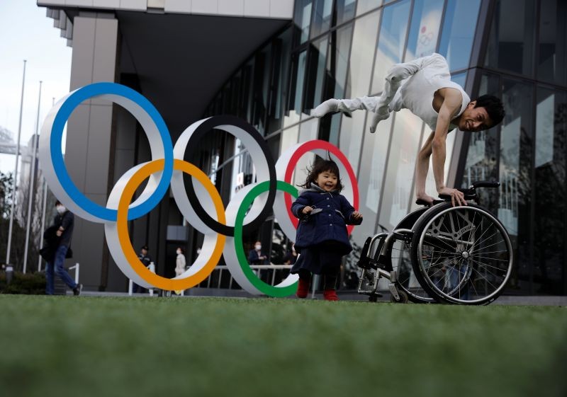 FILE PHOTO: Kenta Kambara, 34, poses for a photo while his daughter Shiori, 2, walks past him, next to an Olympic Rings symbol in front of the Japan Olympic Museum in Tokyo, Japan, February 22, 2020. REUTERS/Kim Kyung-Hoon