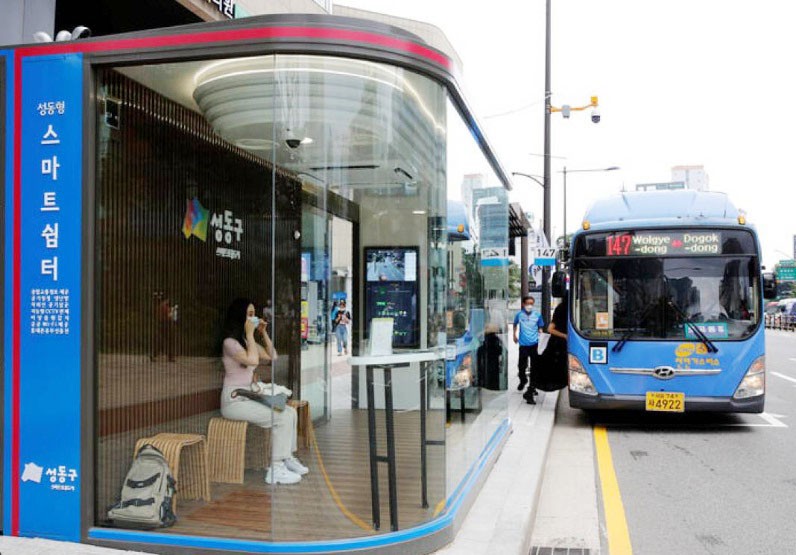 A woman wears a mask inside a glass-covered bus stop in which a thermal imaging camera, UV sterilizer, air conditioner, CCTV and digital signage are set, to avoid the spread of COVID-19 in Seoul, South Korea. (REUTERS File Photo)