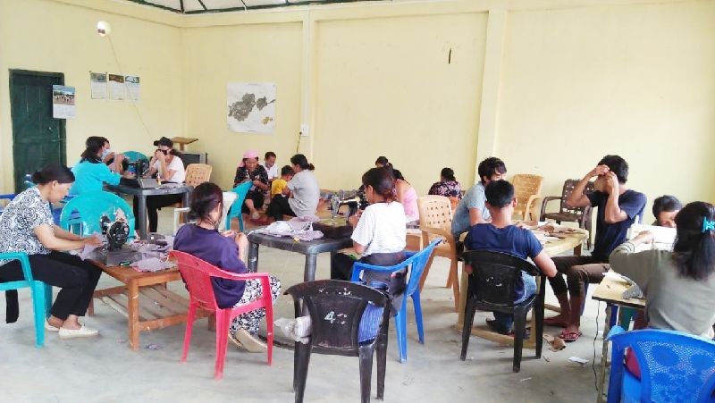 Self Help Groups stitches masks for the villagers.