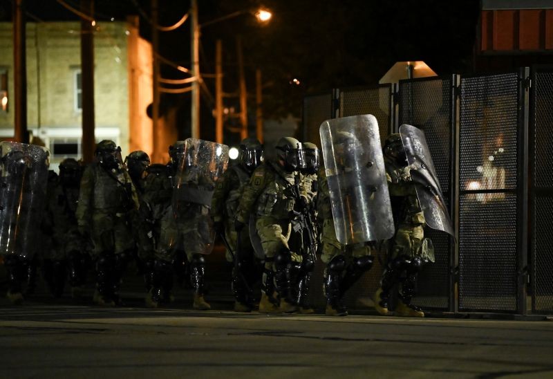 Security forces take position as people protest outside the Kenosha County Courthouse after a Black man, identified as Jacob Blake, was shot several times by police in Kenosha, Wisconsin, US on August 25, 2020. (REUTERS Photo)