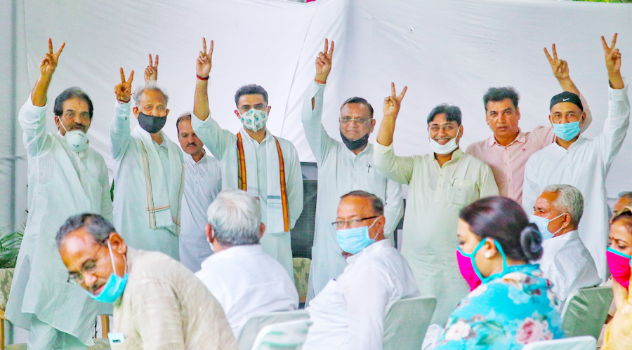 Rajasthan Chief Minister Ashok Gehlot (2L), Congress leaders Sachin Pilot (3L), Avinash Pandey and others flash a victory sign during the MLAs meeting at CM residence, in Jaipur on August 13. (PTI Photo)