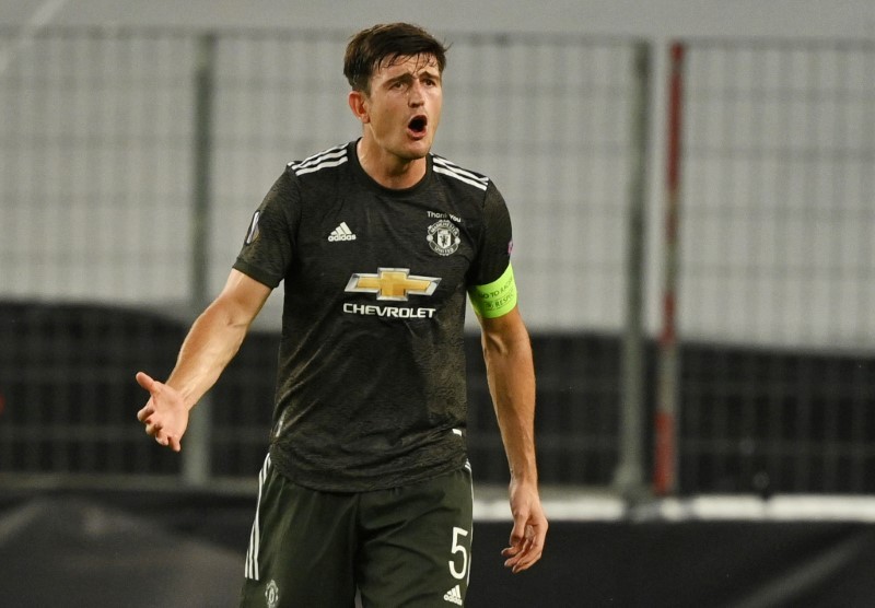 FILE PHOTO: Manchester United's Harry Maguire reacts, as play resumes behind closed doors following the outbreak of the coronavirus disease (COVID-19) Ina Fassbender/Pool via REUTERS/File Photo