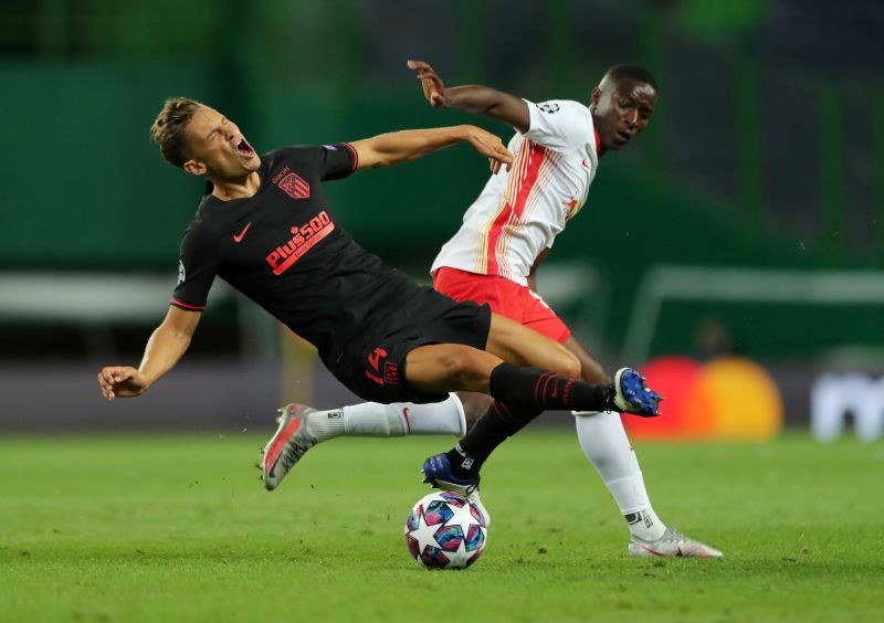 Atletico Madrid's Marcos Llorente in action with RB Leipzig's Amadou Haidara, as play resumes behind closed doors following the outbreak of the coronavirus disease (COVID-19) Miguel A. Lopes/Pool via REUTERS