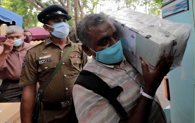 Sri Lankan police and election officials wearing protective masks load ballot boxes and papers onto busses from a distribution center to polling stations ahead of country's parliamentary election which scheduled for August 5th, in Colombo, Sri Lanka on August 4, 2020. (REUTERS Photo)