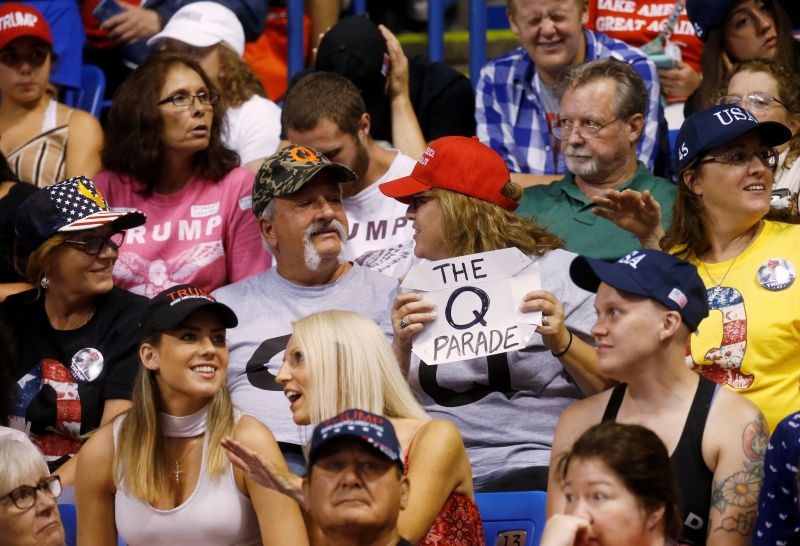 A supporter holds a QAnon sign as U.S. President Donald Trump addresses a campaign rally at Mohegan Sun Arena in Wilkes-Barre, Pennsylvania, U.S.,on  August 2, 2018. (REUTERS File Photo)