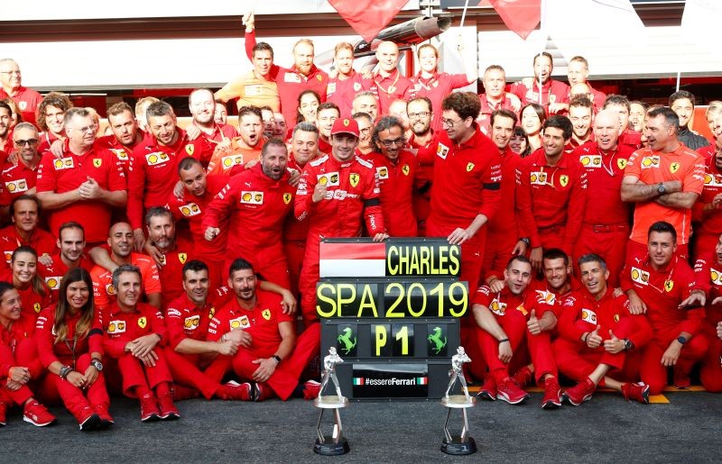 Ferrari's Charles Leclerc celebrates winning the race with team principle Mattia Binotto, Ferrari's Sebastian Vettel (background) and the mechanics REUTERS/Francois Lenoir