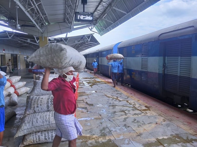 Railway porters loading goods at a railway station in the NFR zone. (Photo Courtesy: NFR)